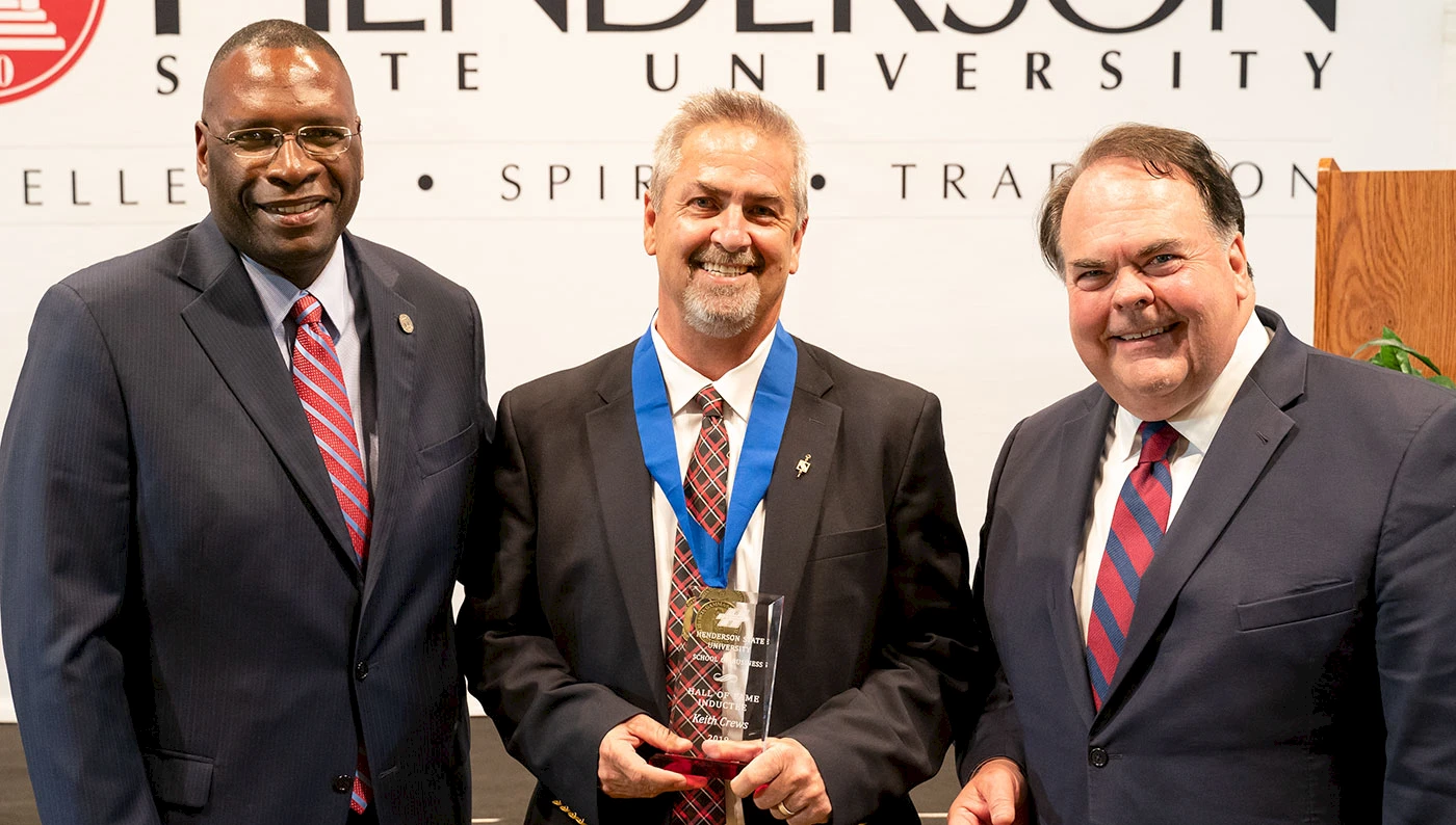Keith Crews is pictured with Henderson President Dr. Glen Jones, left, and School of Business Dean Dr. Marc Miller.